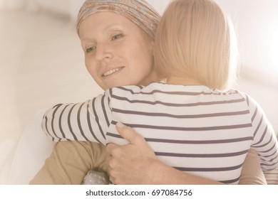 Little Caring Girl Embracing Mother Suffering From Leukemia Disease