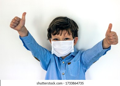 Little Caucasian children boy wearing medical mask protection coronavirus COVID-19 with thumb up on white background isolated,copy space.Selective focus of 4-5 years old cute kid wearing surgical mask - Powered by Shutterstock