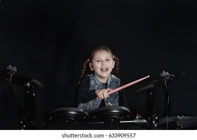 Little Caucasian Girl Drummer Laughting.