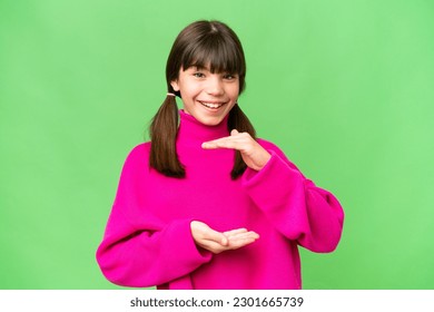 Little caucasian girl over isolated background holding copyspace imaginary on the palm to insert an ad