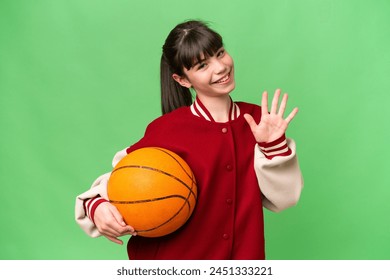 Little caucasian girl playing basketball over isolated background counting five with fingers - Powered by Shutterstock