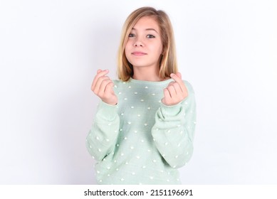 Little Caucasian Kid Girl Wearing Trendy Sweater Over White Background  Doing Money Gesture With Hands, Asking For Salary Payment, Millionaire Business