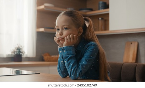 Little Caucasian sad upset child girl sitting at home kitchen alone offended kid schoolgirl feeling disappoint bullied abused lonely schoolchild daughter stressed sit at table school children problem - Powered by Shutterstock