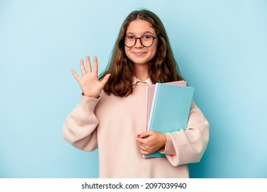 Little caucasian student girl holding books isolated on blue background smiling cheerful showing number five with fingers. - Powered by Shutterstock