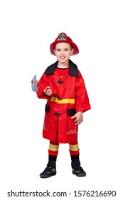 little cheerful boy in a fireman's robe: a red helmet with a coat of arms, coat, pants with stripes and an ax on a white isolated background. CONCEPT children dressing up for parties and New Year