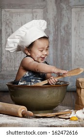 Little Chef.  Adorable baby boy dressed in s chef's hat.  