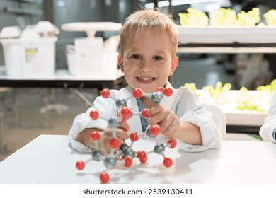 Little child boy scientists holding molecular model and learning science and chemistry in laboratory. Student learning science in classroom. Science and education concept - Powered by Shutterstock