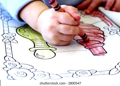 Little Child Coloring In Coloring Book With Crayons