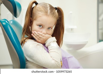 Little child at dentist office in comfortable chair - Powered by Shutterstock