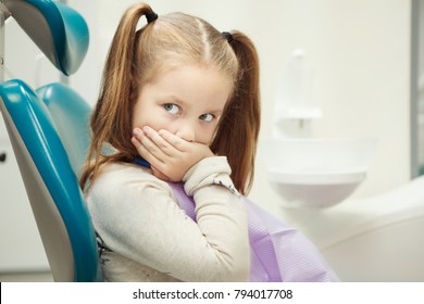 Little child at dentist office in comfortable chair - Powered by Shutterstock