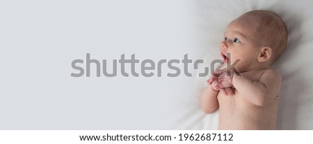 Similar – Newborn lying on bed embraced by her mother