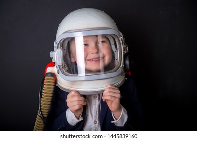 Little child dressed in astronaut helmet costume in empty room. Child autism.  Weird kid. Autistic kid go back to school. 