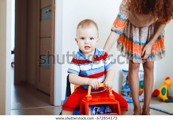 A little child,\
driving around the house