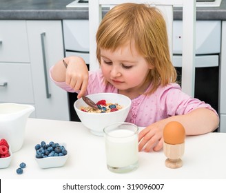 Little Child Eating Muesli For Breakfast