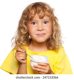 Little child eating yogurt
