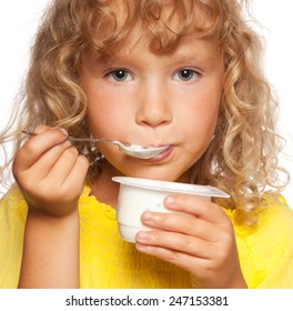 Little child eating yogurt