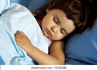 Little Child Girl Asleep In Her Bed