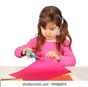 Little Child Girl Cutting With Scissors Over White