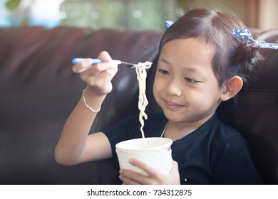 Little Child Girl Eating Cup Noodle With Happy.