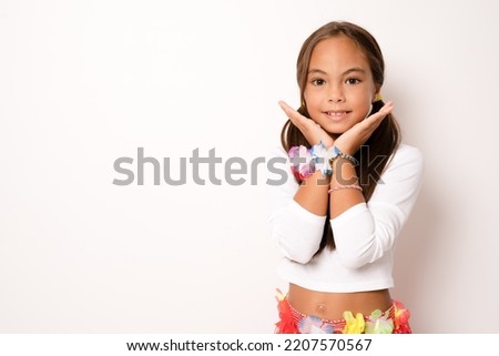little child girl in hawaiian costume standing isolated white background