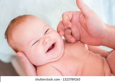 Little Child, The Girl Lies In The Hands Of Her Father. The Child Has Excess Weight And Fat Folds, Requires Dietary Nutrition. The Girl Laughs And Rejoices In Life. Dad Caresses Baby, Tickle Her Cheek