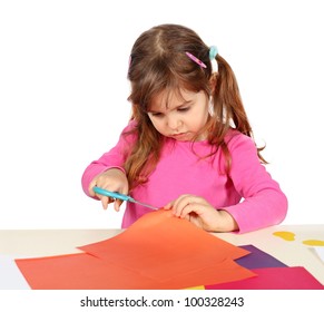 Little Child Girl Making A Cutout With Scissors