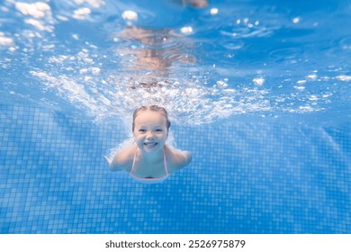 Little child girl swimming underwater in the paddling pool. Diving. Learning infant child to swim. Enjoy swimming and bubbles. - Powered by Shutterstock