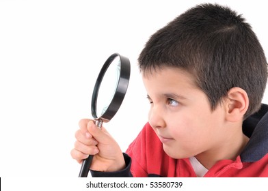 Little child looking through a magnifying glass isolated on white background