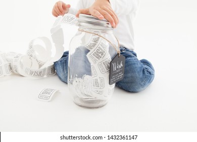 Little Child Making Lots Of Wishes Using A Wish Jar, Wish Granted! 