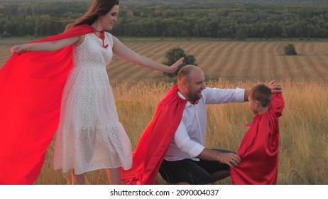 Little Child With Mother And Father Playing Superheroes Dressed In Red Cloaks, Happy Family, Brave Savior Costume, Fantastic Childhood Dream Heroes, Fearless Kid Boy Winner, Fun To Play The Game