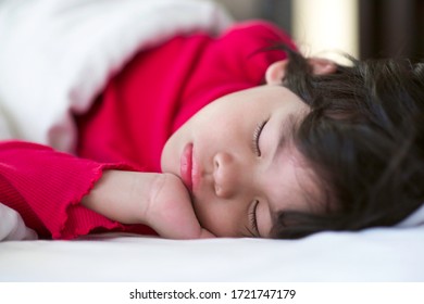 Little Child Napping.Boy Sleeping On Bed With White Bedsheet And Comforter.Preschooler Nap Time.Cute Asian Young Male With Eyes Closed Lying Down On Mattress In The Morning.