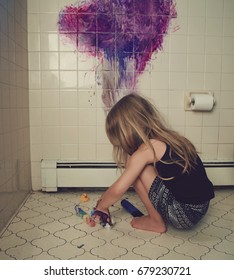 A Little Child Is Painting On A Bathroom Wall Making A Mess For A Funny Parenting Discipline Concept.