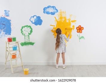 Little Child Painting Wall With Roller Brush Indoors