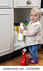Little Child Playing With Cleaning Products At Home