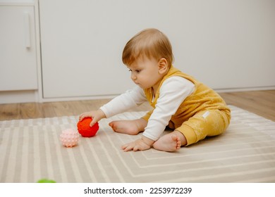 little child is playing with sensory balls - Powered by Shutterstock