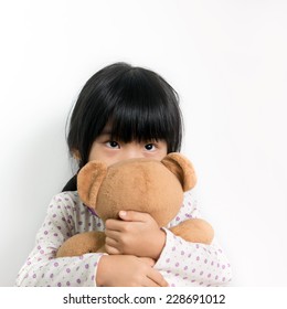 Little Child In Pyjamas Holding Teddy Bear