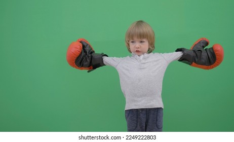 Little child with red gloves prepare for fight, green screen - Powered by Shutterstock