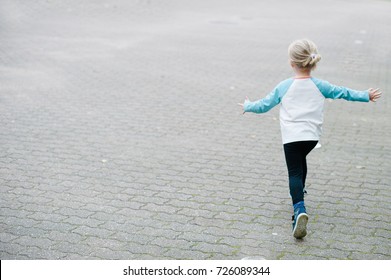 Little Child Running Away. Back View.