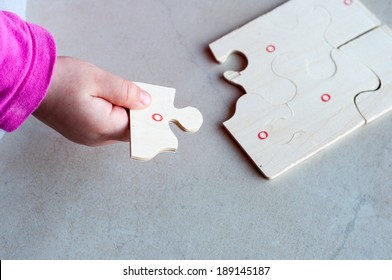 Little child solving a puzzle.
