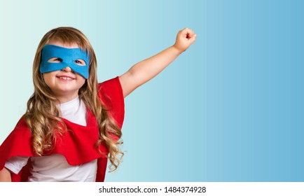 Little child superhero with yellow cloak and star. Happy smiling kid in glasses ready for education. Success, motivation concept. Back to school. Little businessman isolated on blue, Boy superhero. - Shutterstock ID 1484374928