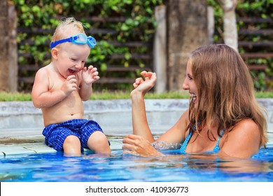 Little child in underwater goggles sit on poolside, has fun - baby splashing with mother in swimming pool. Family lifestyle and summer holiday water sports outdoor activity and lessons with parents. - Powered by Shutterstock