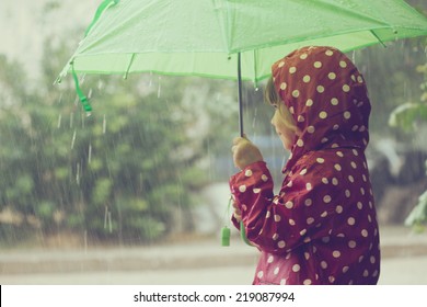 Little Child Walking In The Rain