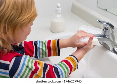 Little Child Washing Hands With Soap In The Bathroom