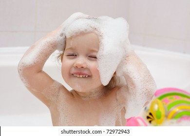 Little Child Is Washing Her Hair In Bath