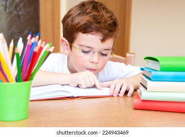 Little Child Wearing Glasses Reading A Book