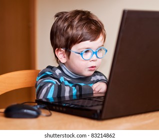 Little Child Wearing Glasses Using Computer