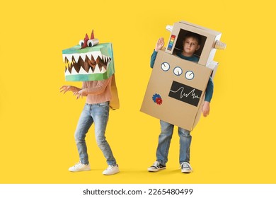 Little children in cardboard costumes on yellow background - Powered by Shutterstock