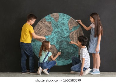 Little Children Drawing Planet On Dark Background. Earth Day Celebration