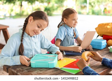 Little children having lunch outdoors - Powered by Shutterstock