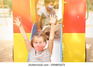 Little Children With Medical Face Masks On Playground During Covid-19 Quarantine